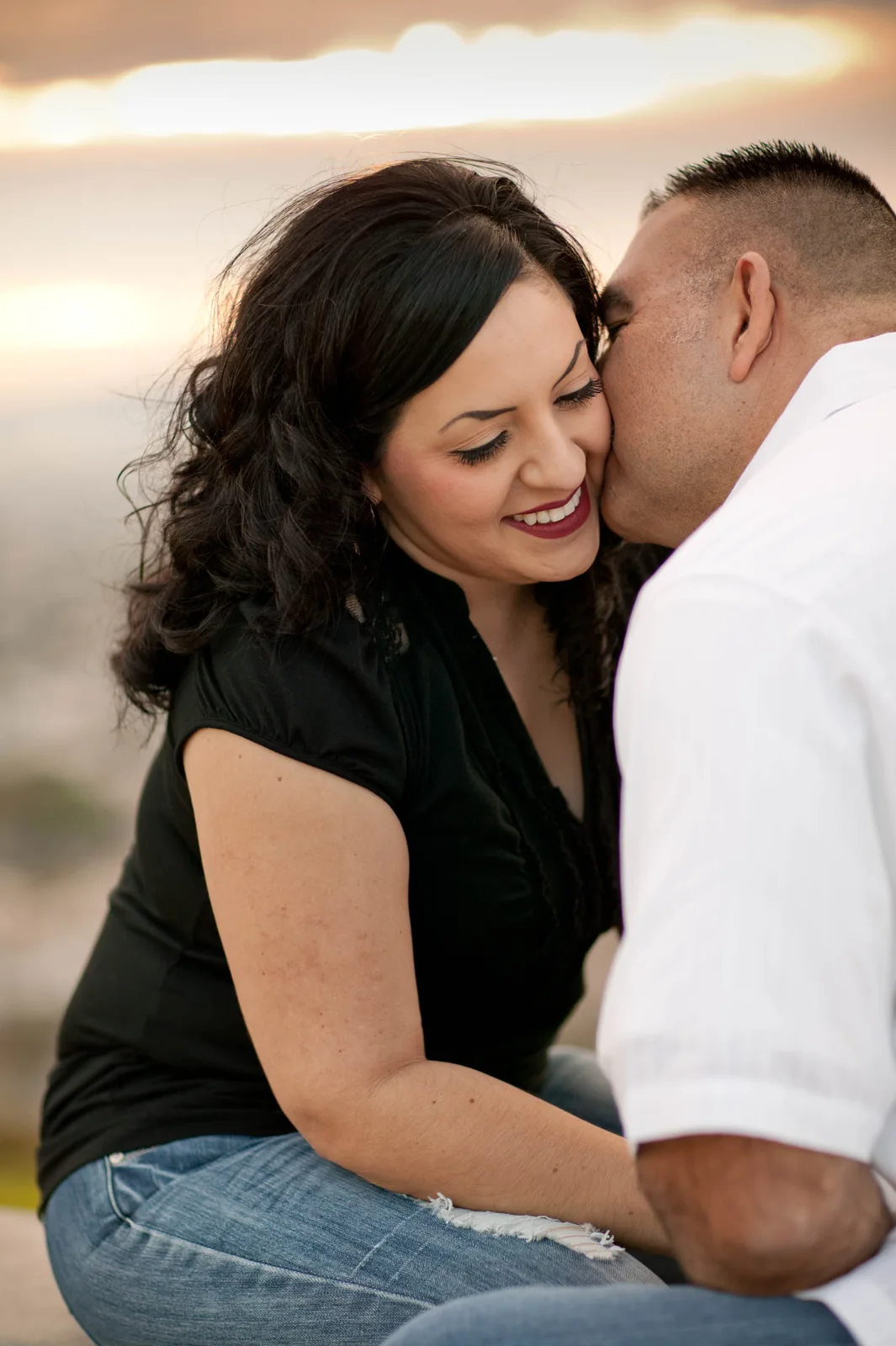 An engaged couple embracing in the evening light